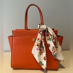 Orange purse with removable strap and scarf